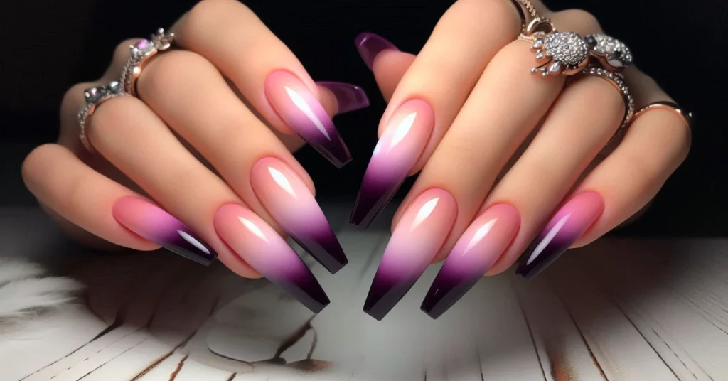 An ombre design of long coffin nails transitioning from soft pink at the base to a rich purple at the tips.