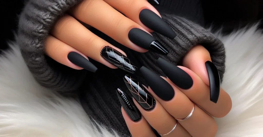 Black matte coffin nails with a few glossy black geometric accents.