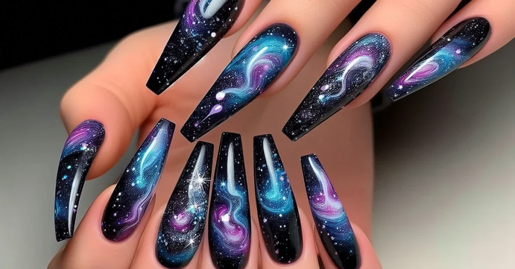 Galaxy nails with dark blue, purple, and black swirls.